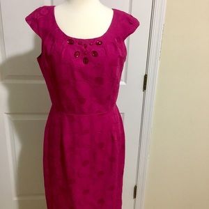 Fuschia embossed dress with jewels at neckline.